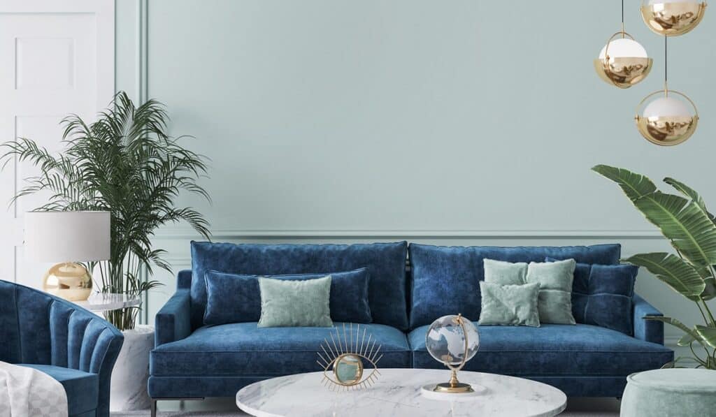 Home interior mockup with blue sofa, marble table and tiffany blue wall decor in living room Living room with warm neutral walls and natural wood details