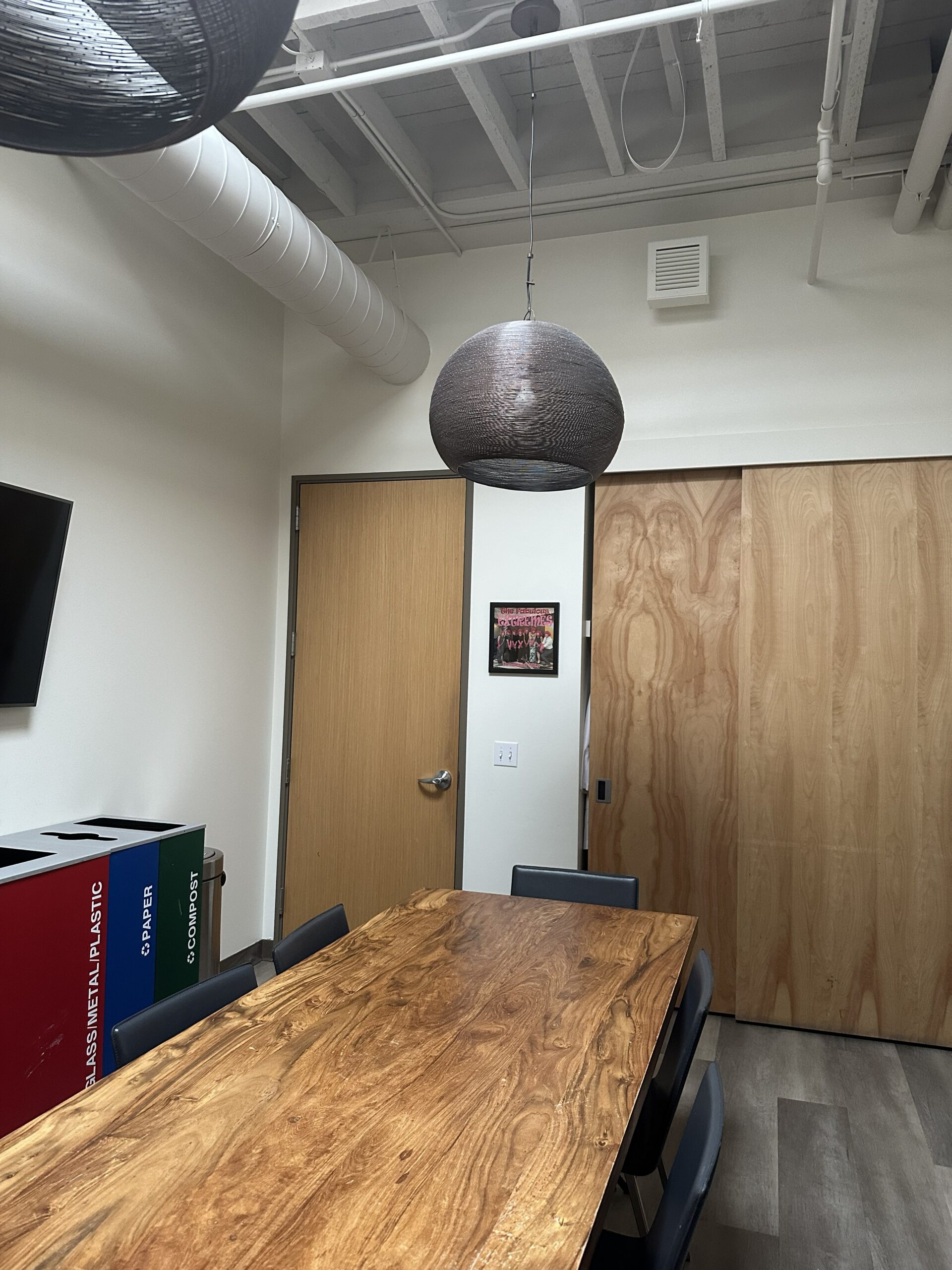 Professional office interior painting services A clean, modern office meeting room with freshly painted white walls and a large wooden table.