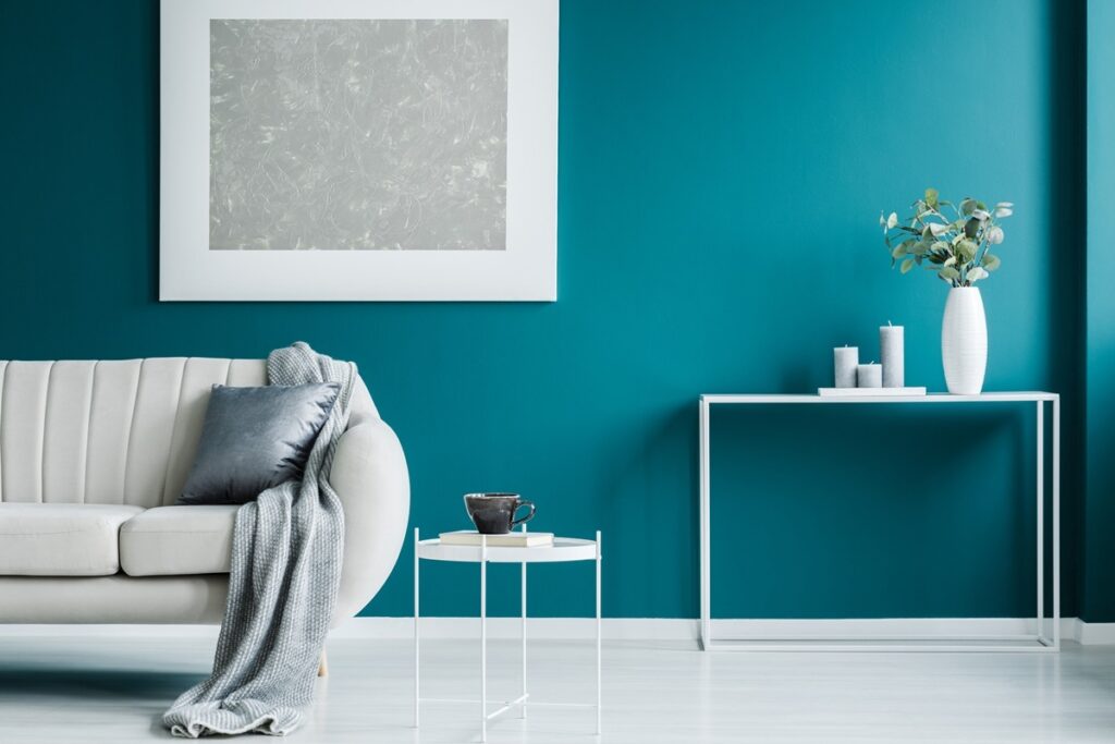 Painting and blanket Neutral living room with freshly painted walls and natural light