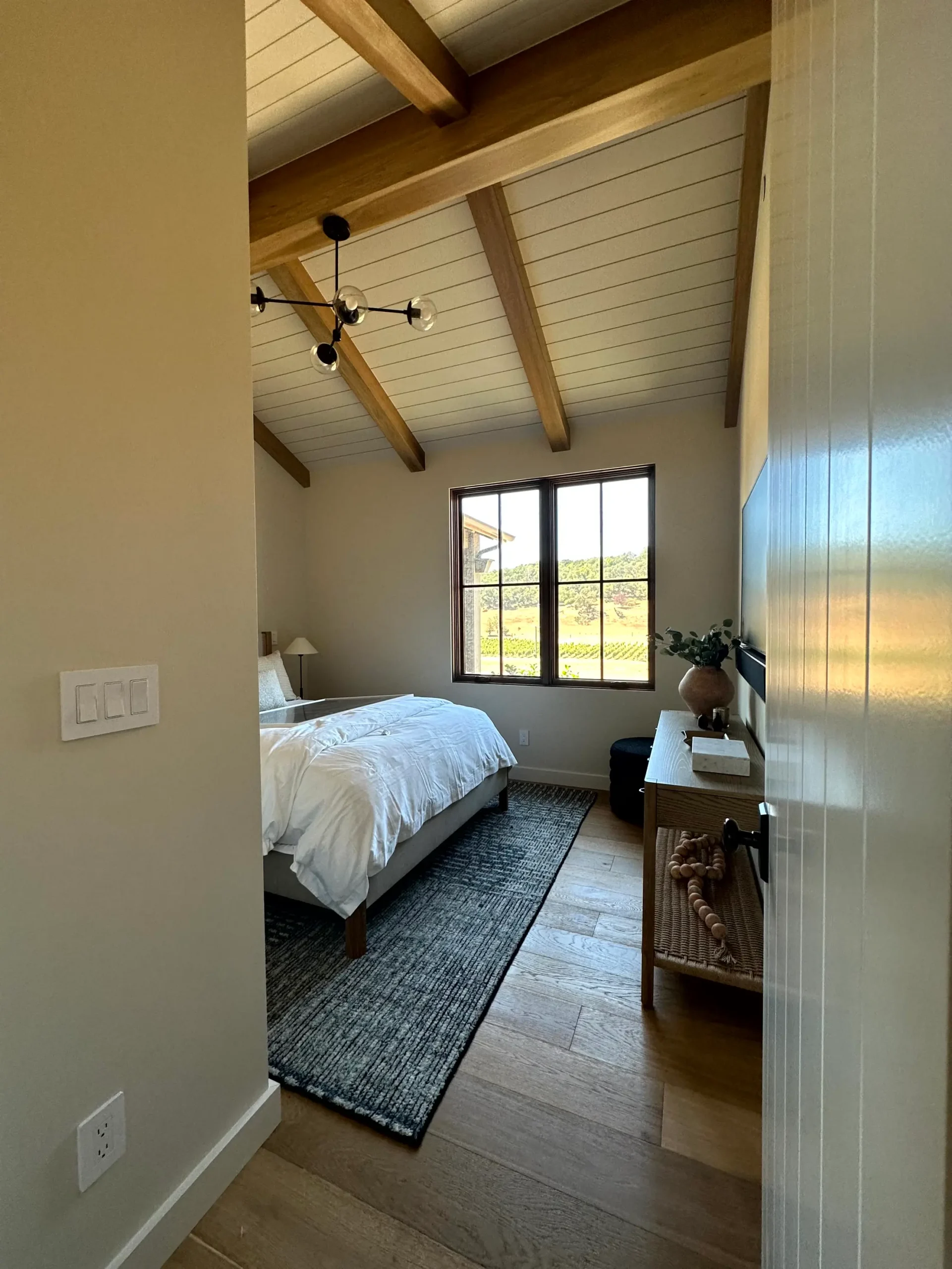 Modern Bedroom Interior Painting with Neutral Walls and Shiplap Ceiling Freshly painted modern bedroom showcasing light tan walls, white shiplap ceiling, and elegant wooden accents.